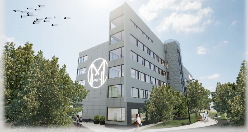 Havainnekuva modernista harmaasta rakennuksesta vehreässä ympäristössä.