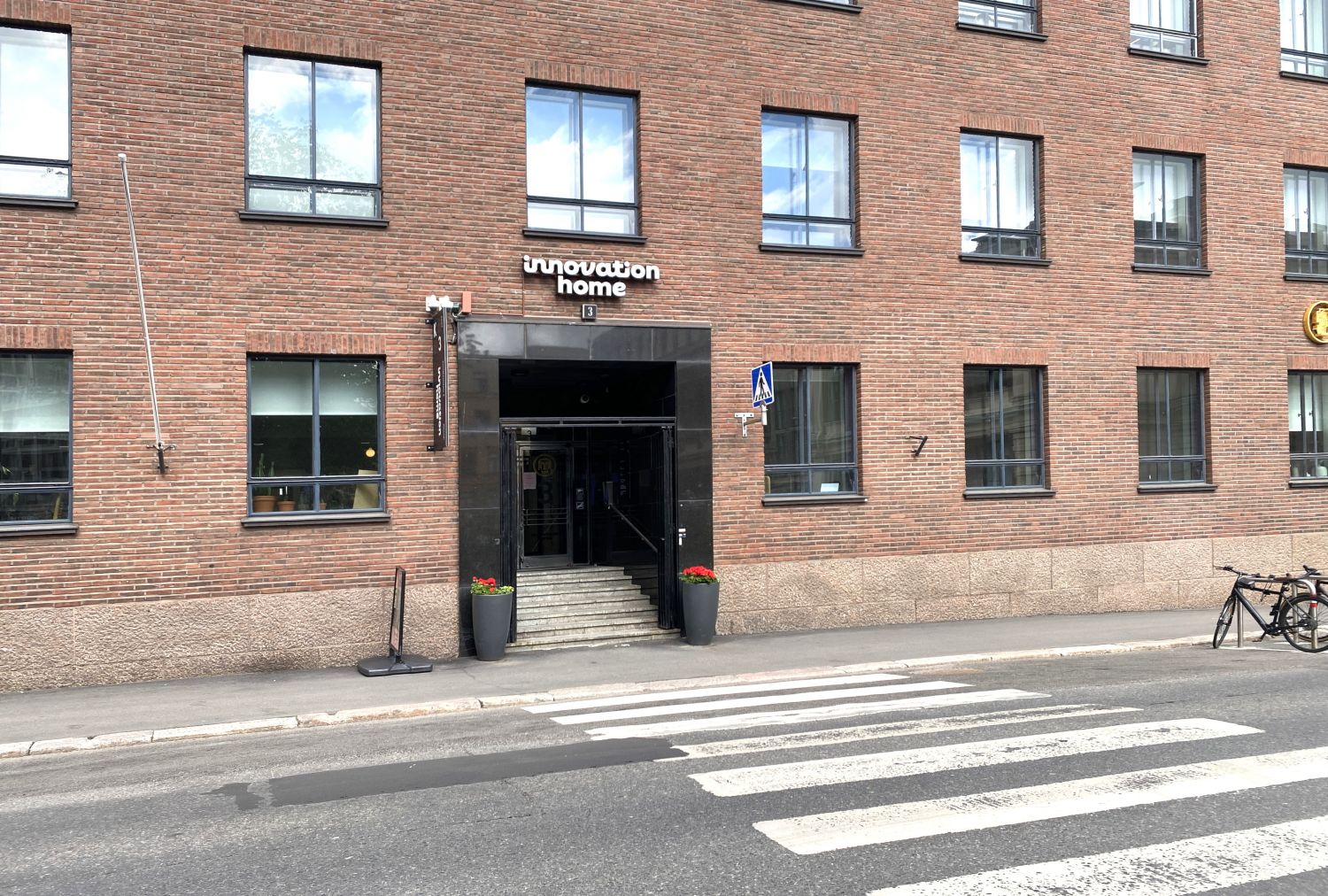 Punatiilisen rakennuksen julkisivu ja 